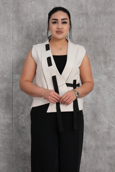  This womens vest is offered in a stylish and elegant design in beige color. The vest is made from 100% cotton, providing a soft and comfortable texture. It is available in sizes S, M, L, and XL. The model features black strip details and tying details on the front. This vest is an excellent choice for both daily wear and special occasions.