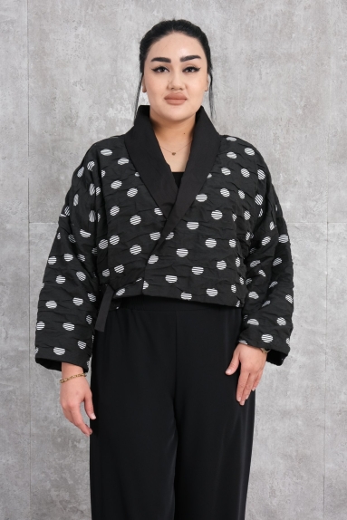  This womens jacket features a stylish and modern design. As seen on the model, the jacket is black in color with white circular patterns. The jacket is made entirely of polyester fabric, ensuring quality and durability while also providing comfortable wear. The jackets short form and relaxed fit make it ideal for everyday use. It is available in three different sizes: S, M, and L.