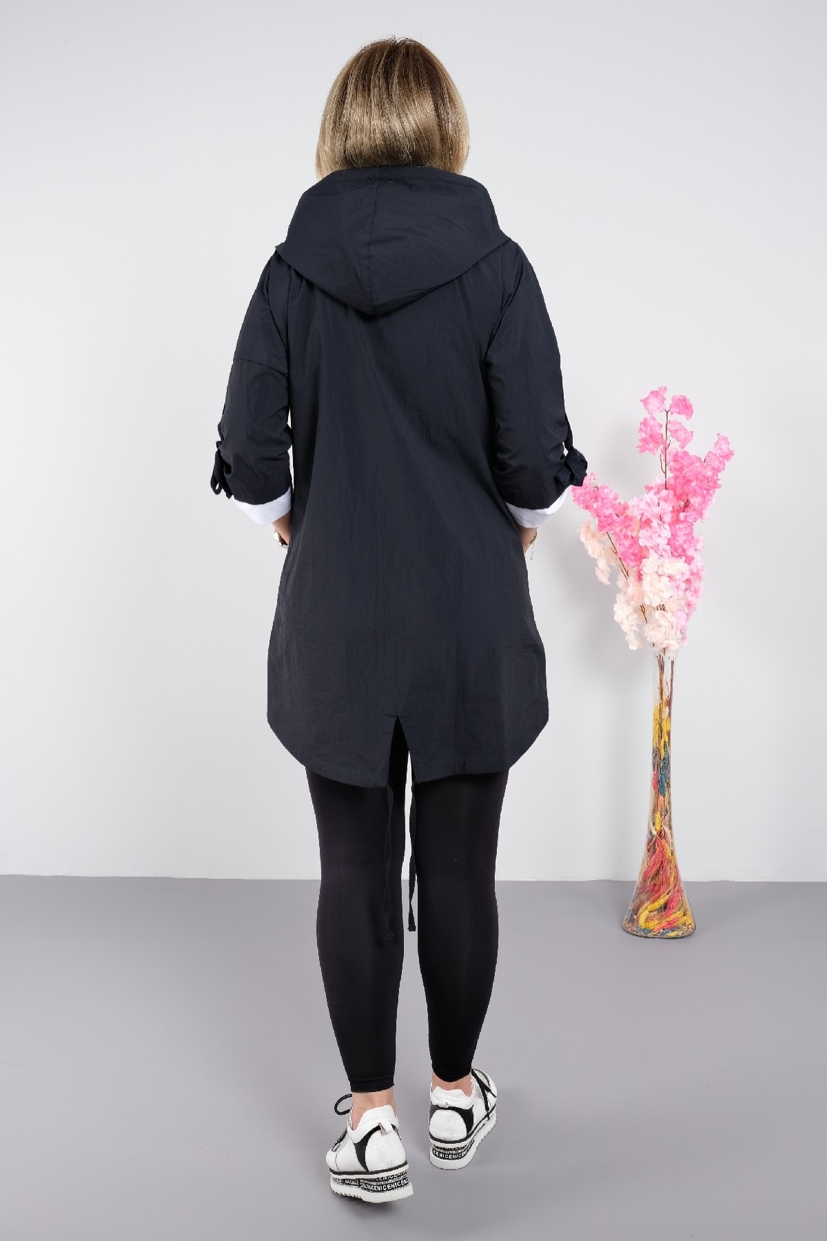 Stylish women's trench coat for plus sizes with a hood with a zipper and pockets