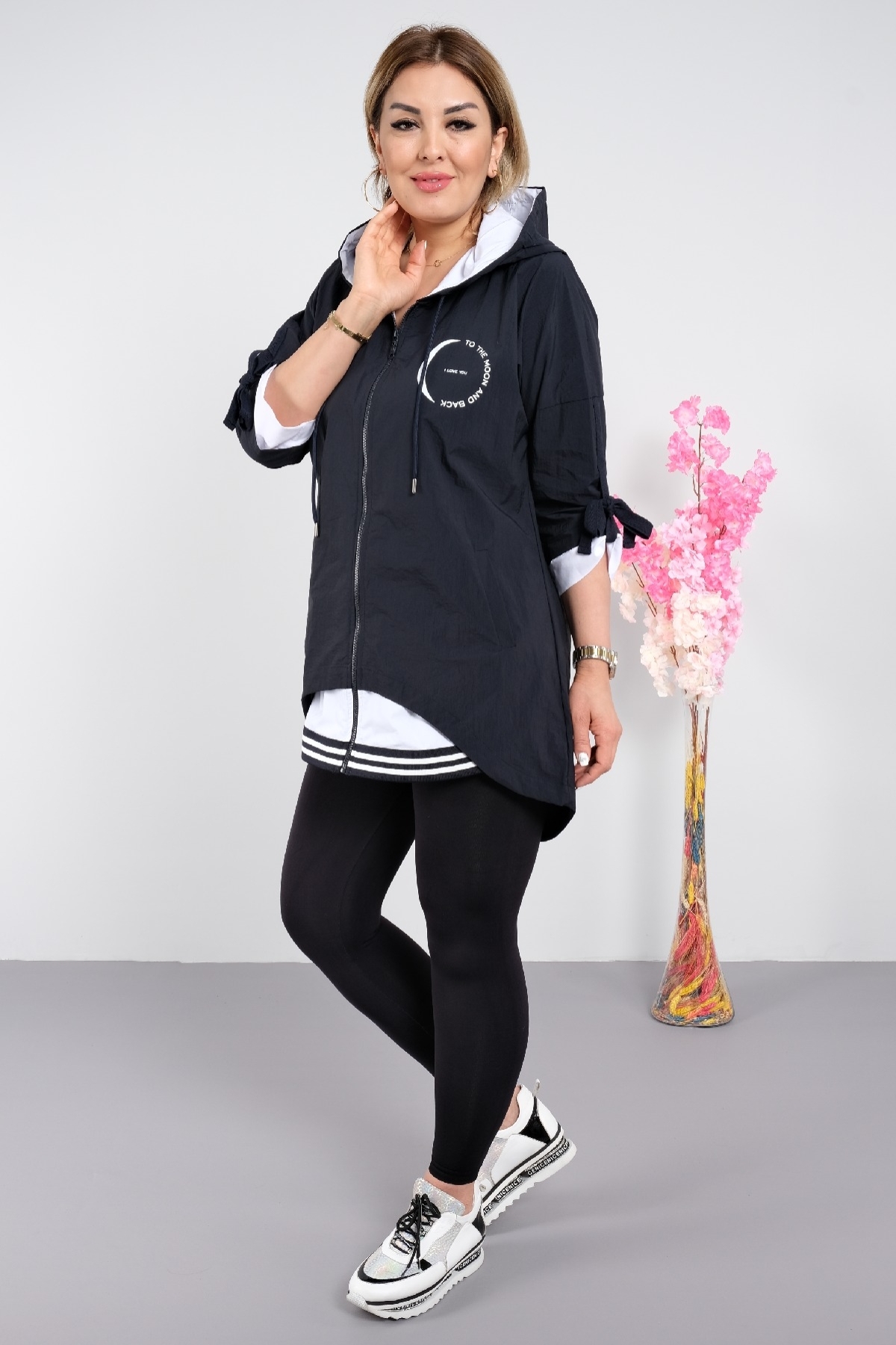 Stylish women's trench coat for plus sizes with a hood with a zipper and pockets