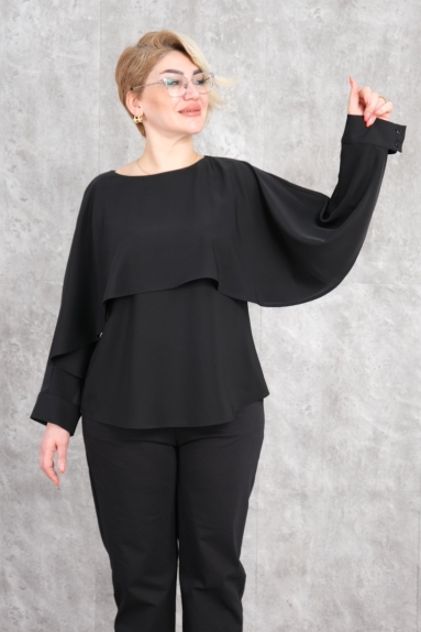  This plus-size womens blouse in black offers a blend of elegance and comfort. Made entirely from 100% Polyester fabric, it is both lightweight and durable. The blouses loose fit and elegant drapery combine style and ease. Details on the front and back enhance its modern and graceful appearance. Available in sizes 42, 44, 46, and 48, it is designed to cater to different body types.