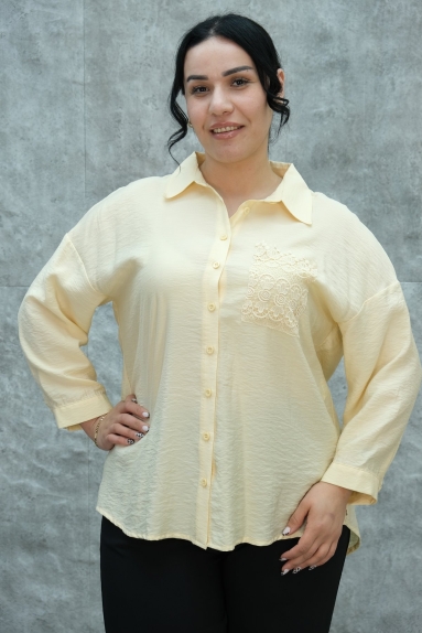  This plus-size womens blouse stands out with its elegant design and striking details. The blouse is yellow and available in sizes 42, 44, 46, and 48. The fabric content is 65% cotton, 30% polyester, and 5% elastane. The front of the blouse features button closures and a lace detail on the right chest. The back showcases elegant lace details and crisscross laces, adding to the blouses sophistication while providing comfort with its relaxed fit.