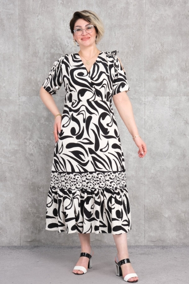  This plus-size womens dress features a chic and comfortable design. The black color can be easily worn in any season and setting. The fabric is 100% viscose, providing softness and lightness for daily comfort. Available in sizes 42, 44, 46, and 48, its perfect for accommodating different body types. The front has a V-neckline and short sleeves. The patterned design adds a modern and eye-catching look to the dress, while the lace details at the bottom enhance its elegance.
