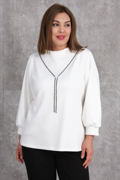  This plus-size womens blouse is an elegant and stylish piece in white. Available in sizes 50, 52, 54, and 56. The fabric composition is 75% polyester, 20% cotton, and 5% lycra. The high-quality fabric blend ensures both comfort and durability. Its long-sleeved design makes it suitable for both casual and semi-formal settings. The front of the blouse features tassel details, adding a modern and sophisticated touch. The back has a simple cut, offering a minimalist look. This blouse combines comfort and elegance, making it a staple in your wardrobe.